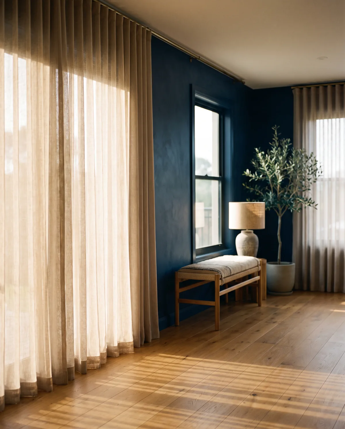 Floor length linen curtains softening the afternoon light in a living room